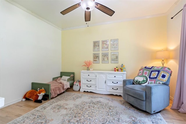 bedroom with ceiling fan, ornamental molding, and light wood-type flooring