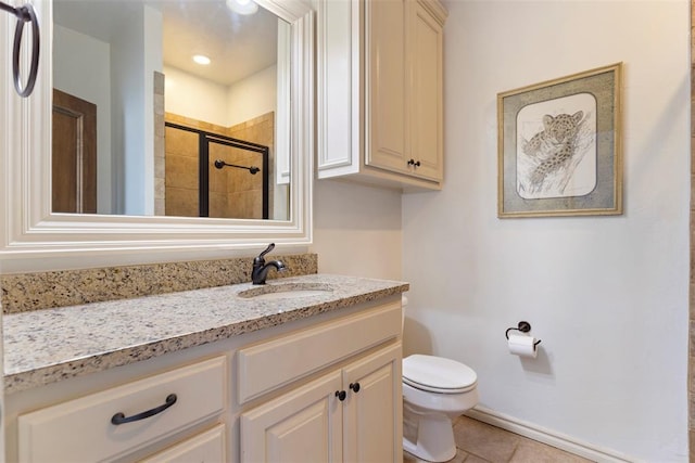 bathroom featuring vanity, tile patterned flooring, a shower with door, and toilet