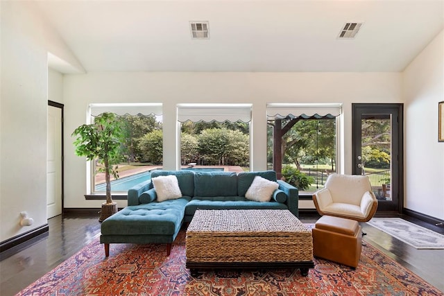 living room featuring lofted ceiling and a wealth of natural light