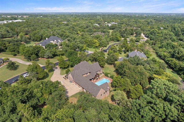 birds eye view of property with a forest view