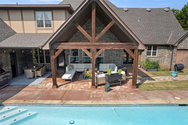 outdoor pool with a patio, area for grilling, and an outdoor hangout area