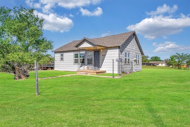 back of house featuring a yard