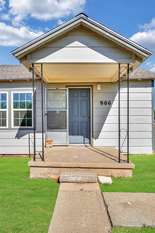 doorway to property featuring a yard