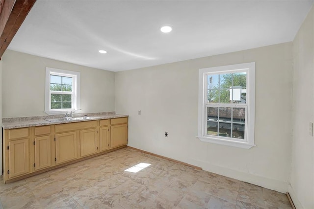 kitchen with light stone countertops and sink