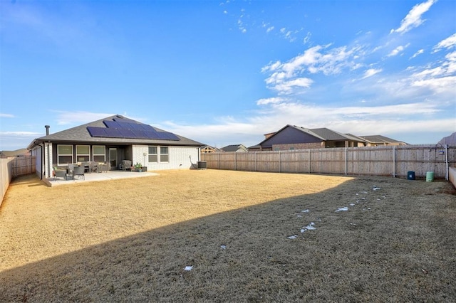 rear view of house with cooling unit, a patio area, and solar panels