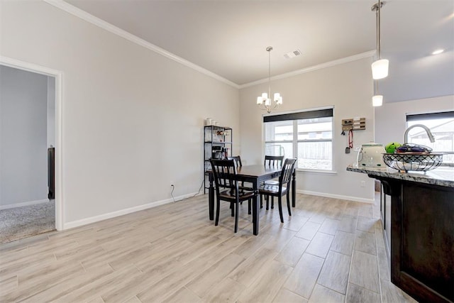 dining area featuring ornamental molding and a chandelier