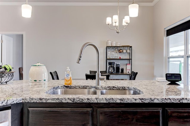 kitchen featuring decorative light fixtures, sink, dark brown cabinets, and an inviting chandelier