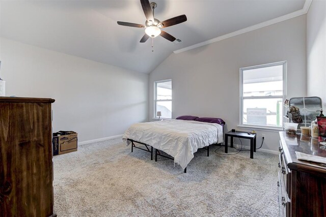 carpeted bedroom featuring ceiling fan, ornamental molding, and vaulted ceiling