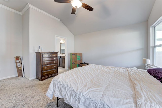 carpeted bedroom with ceiling fan, ensuite bathroom, lofted ceiling, and multiple windows