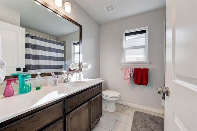 bathroom featuring toilet, tile patterned floors, and vanity