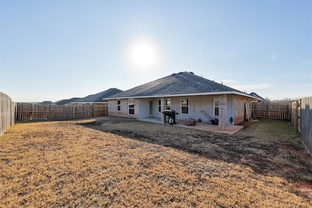 rear view of property featuring a patio area and a yard