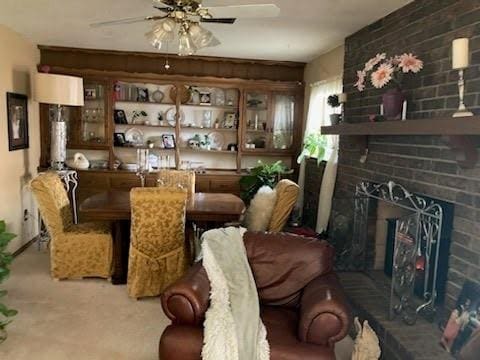 interior space with carpet floors, ceiling fan, and a fireplace