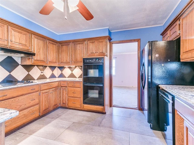 kitchen featuring black appliances, ceiling fan, backsplash, light stone counters, and crown molding