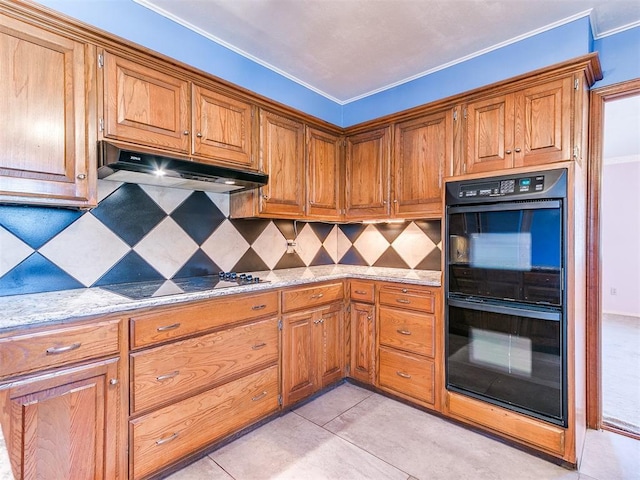 kitchen with light tile patterned floors, decorative backsplash, light stone countertops, ornamental molding, and black appliances