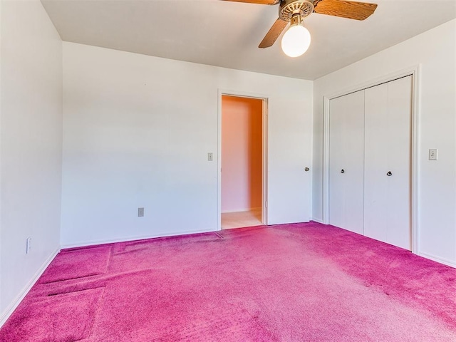 unfurnished bedroom featuring ceiling fan, a closet, and carpet flooring