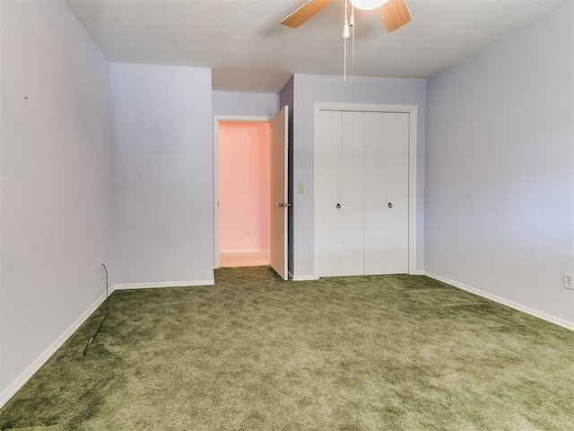 unfurnished bedroom with ceiling fan, a closet, and dark colored carpet