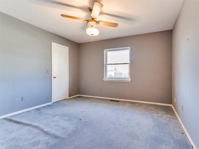 empty room featuring ceiling fan and carpet