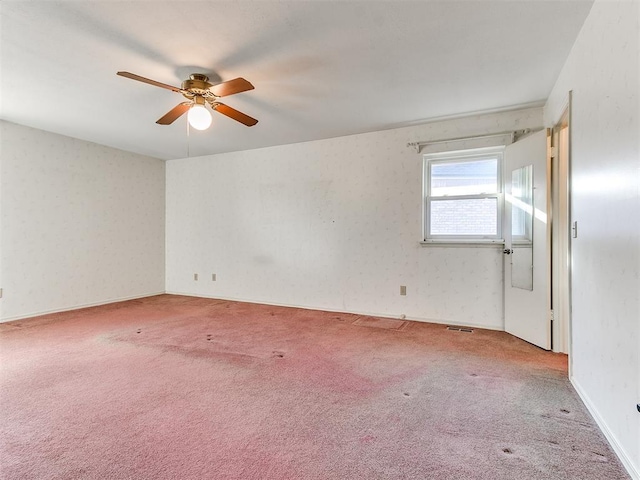 carpeted spare room with ceiling fan