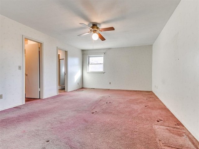 spare room featuring carpet floors and ceiling fan