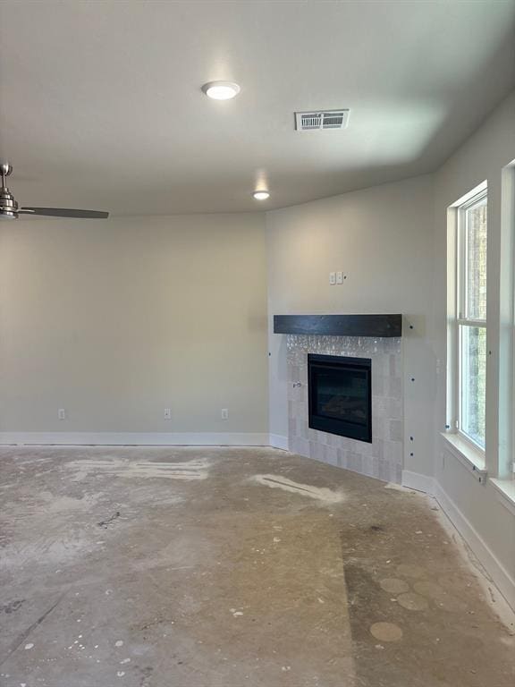 unfurnished living room featuring a healthy amount of sunlight and a fireplace