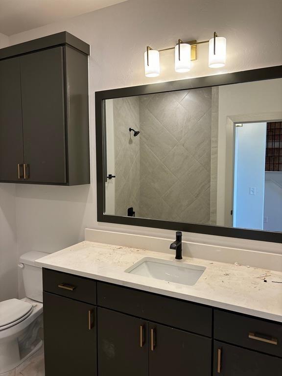 bathroom featuring vanity and toilet