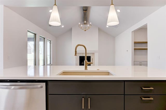 kitchen featuring pendant lighting, dishwasher, sink, and vaulted ceiling with beams