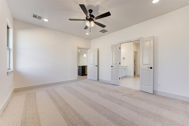 unfurnished bedroom with light carpet and ensuite bath