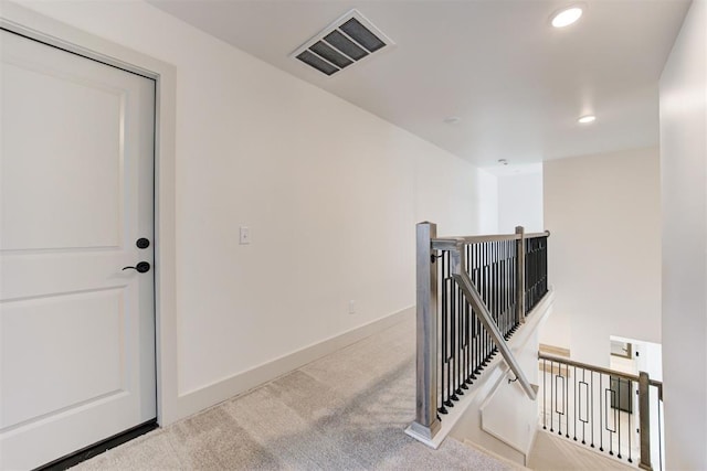 stairway featuring carpet flooring