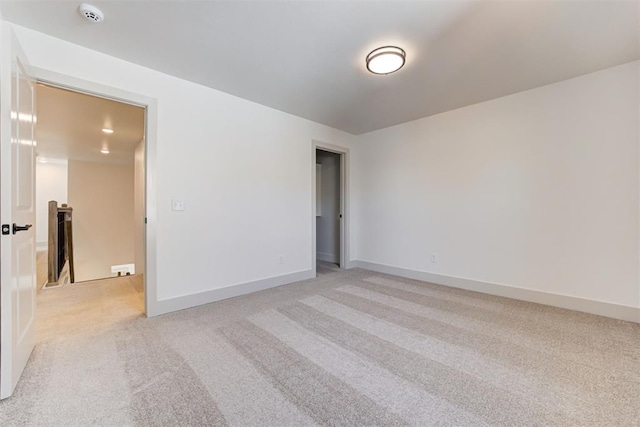 unfurnished room featuring light carpet