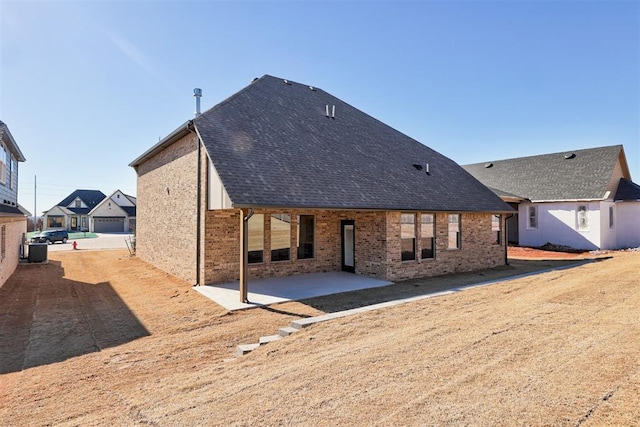 back of house featuring a garage and a patio