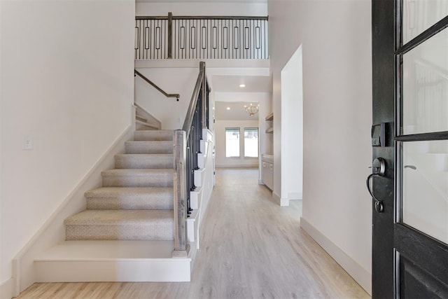 foyer featuring a chandelier and light wood-type flooring