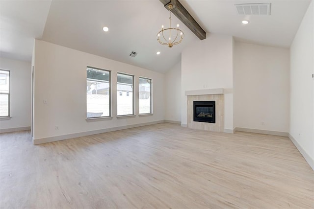 unfurnished living room featuring a tile fireplace, high vaulted ceiling, beamed ceiling, a chandelier, and light wood-type flooring