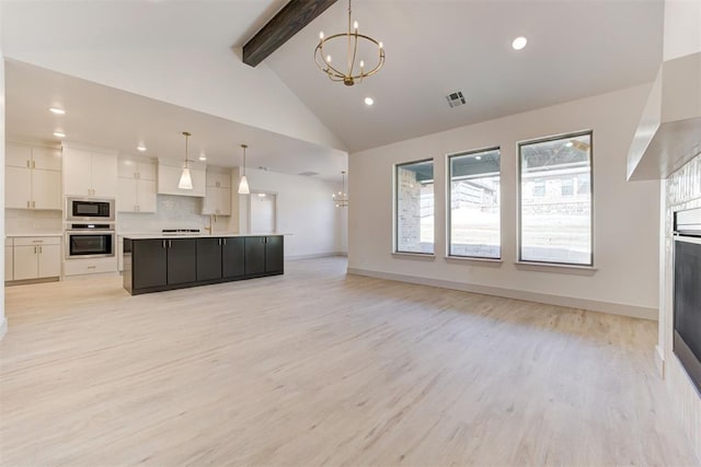 kitchen featuring decorative light fixtures, white cabinetry, oven, a chandelier, and a spacious island