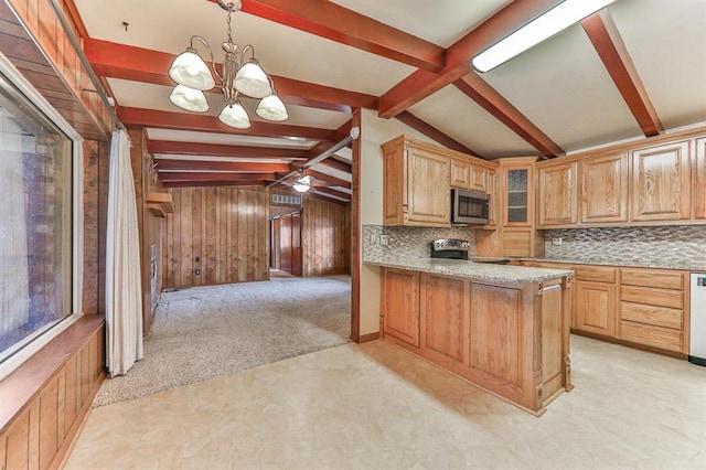 kitchen with appliances with stainless steel finishes, decorative light fixtures, lofted ceiling with beams, backsplash, and light colored carpet