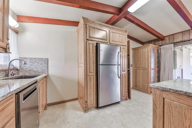 kitchen with sink, light stone counters, stainless steel appliances, beam ceiling, and backsplash