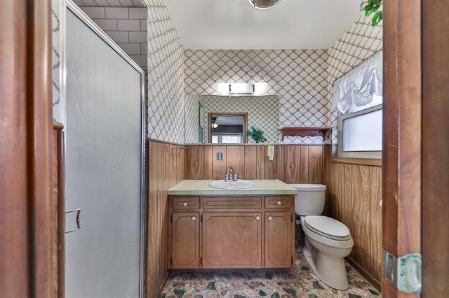 bathroom with vanity, an enclosed shower, and toilet