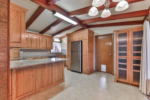 kitchen featuring stainless steel fridge, hanging light fixtures, vaulted ceiling with beams, backsplash, and kitchen peninsula