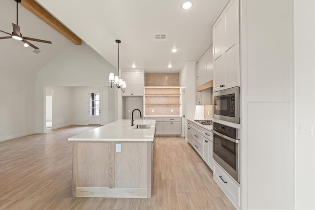 kitchen with visible vents, a sink, light wood finished floors, and stainless steel appliances