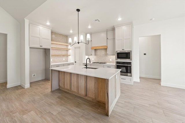 kitchen featuring open shelves, oven, baseboards, built in microwave, and a sink