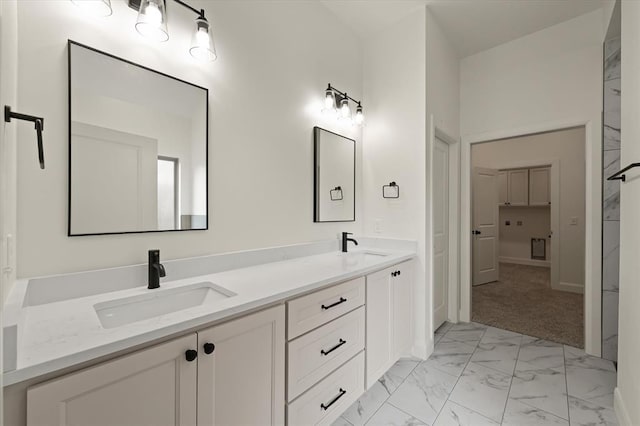 bathroom with double vanity, baseboards, a sink, and marble finish floor