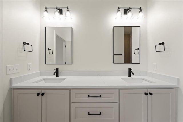 full bathroom featuring double vanity and a sink
