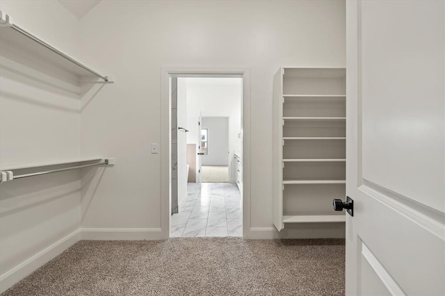 spacious closet with marble finish floor