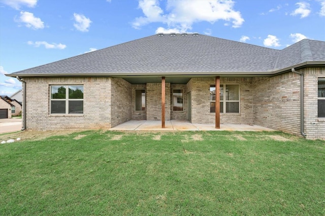 back of house featuring brick siding, roof with shingles, and a patio area