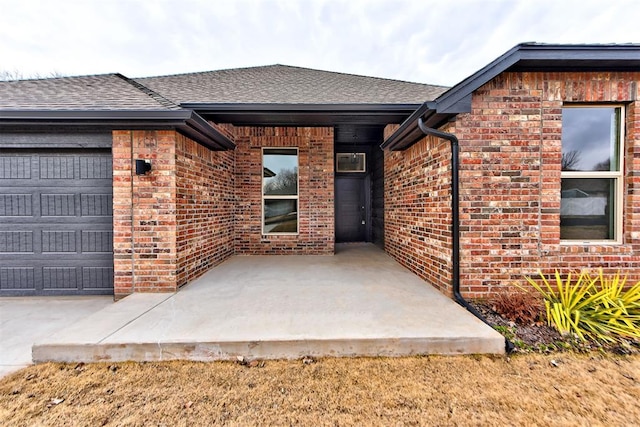 view of exterior entry with a garage