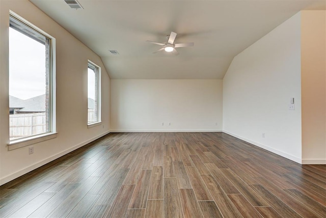 unfurnished room with ceiling fan, vaulted ceiling, and dark hardwood / wood-style flooring