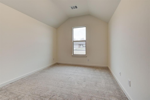 bonus room with light carpet and lofted ceiling