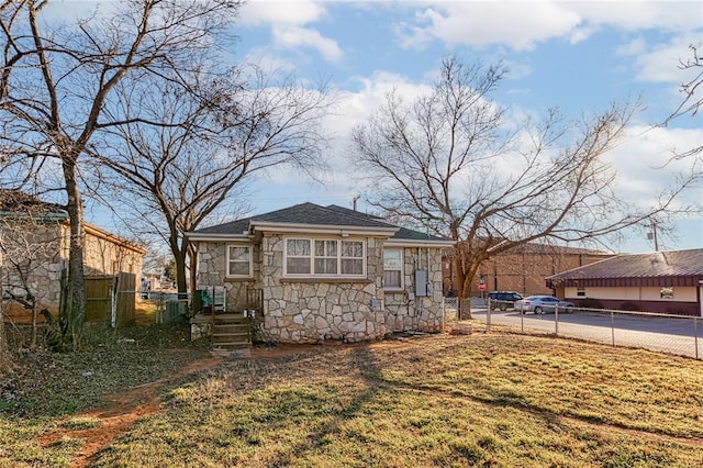 back of property featuring a lawn