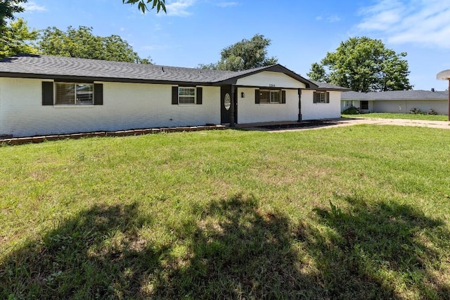 ranch-style home with a front lawn