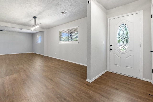 entrance foyer with a textured ceiling and dark wood-type flooring