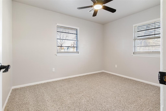 empty room featuring plenty of natural light, baseboards, and carpet